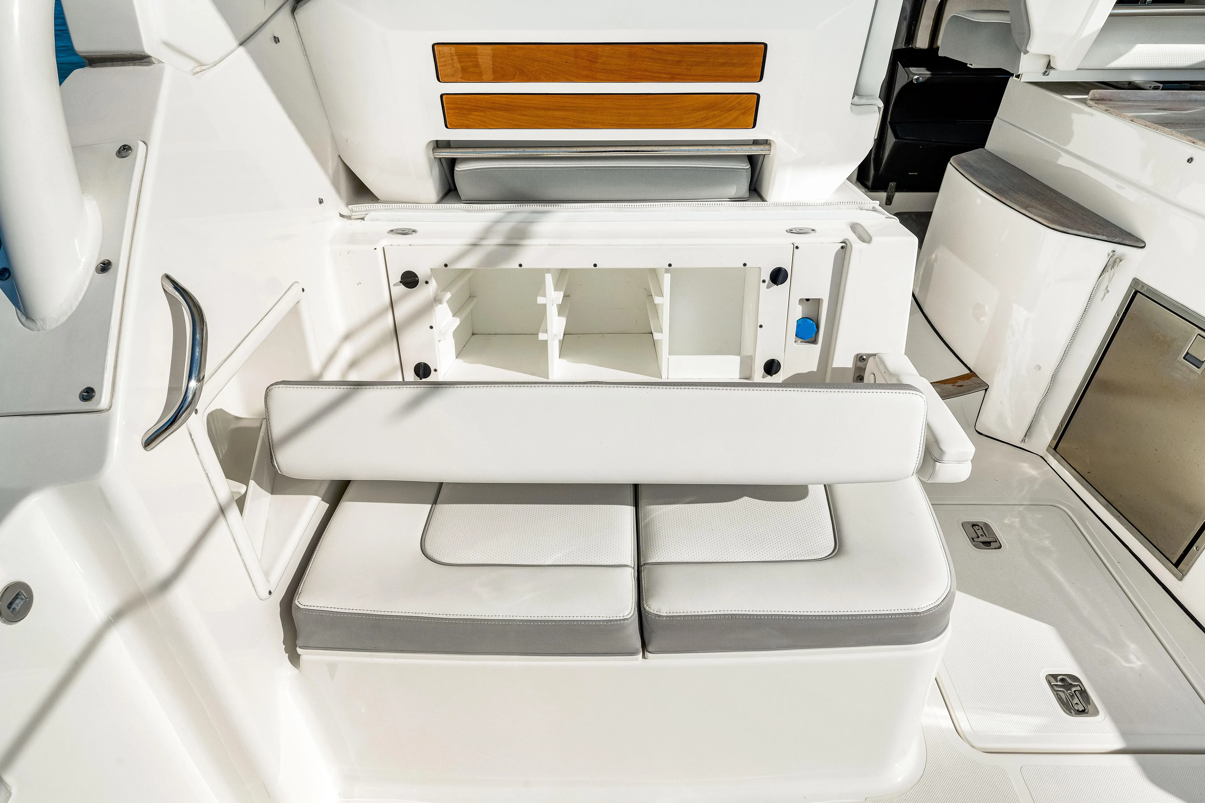 Conspirasea Yacht Photos Pics 2021 Pursuit DC 365 Dual Console boat interior with white seating and storage compartment.