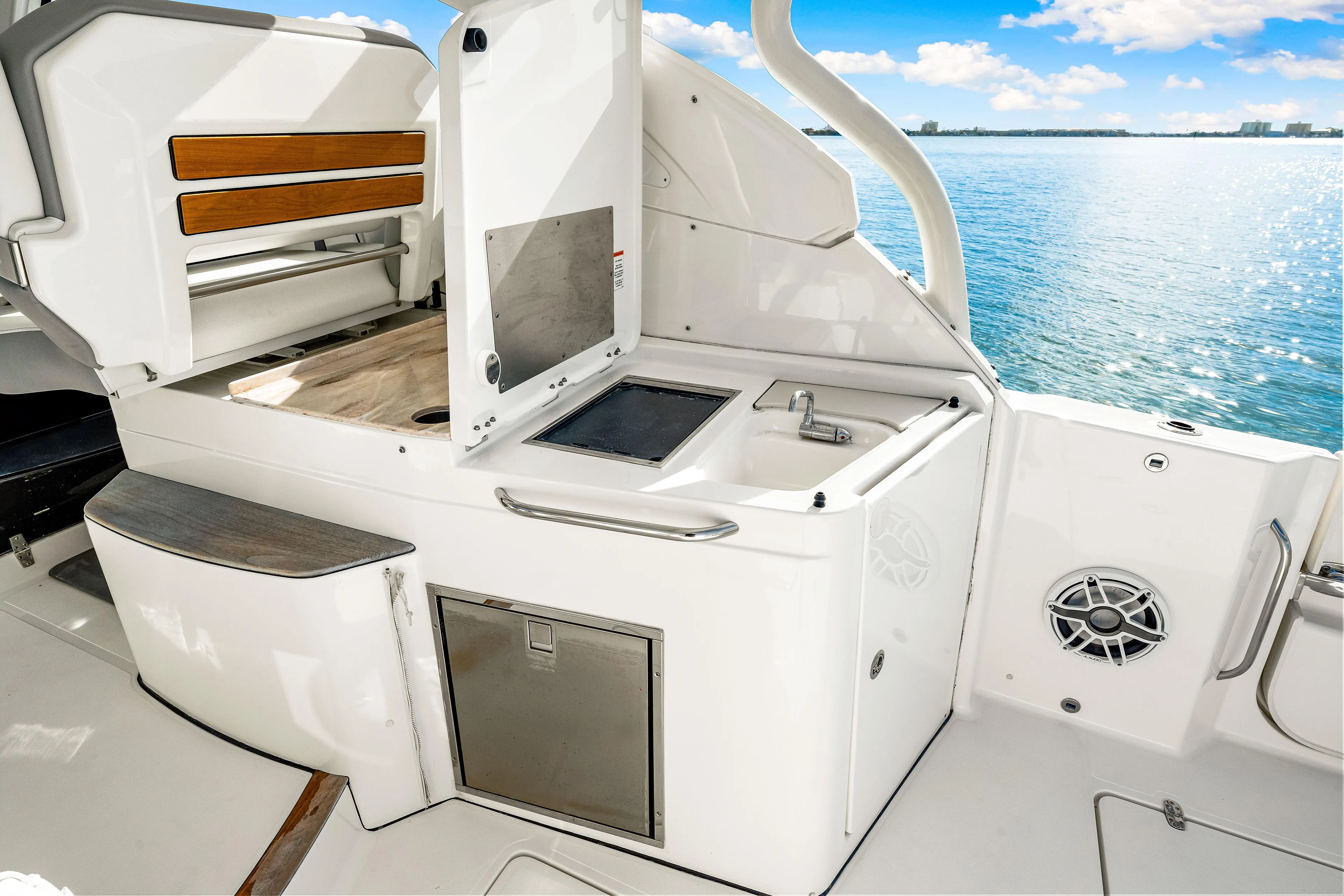Conspirasea Yacht Photos Pics 2021 Pursuit DC 365 Dual Console boat interior with kitchenette and ocean view.