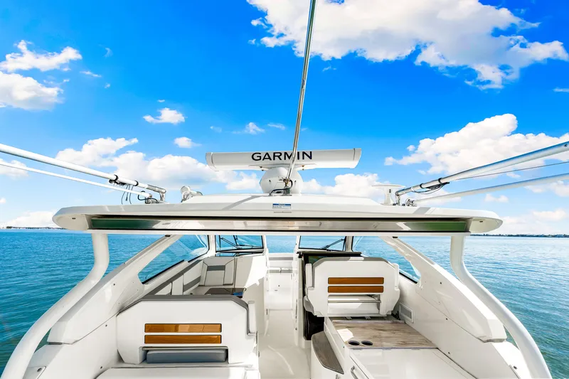 Conspirasea Yacht Photos Pics 2021 Pursuit DC 365 Dual Console boat on water under blue sky.