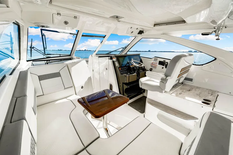 Conspirasea Yacht Photos Pics 2021 Pursuit DC 365 Dual Console interior with seating, helm, and ocean view.