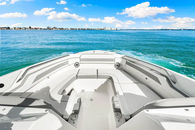 Conspirasea Yacht Photos Pics 2021 Pursuit DC 365 Dual Console boat on open water, clear skies, and distant shoreline.
