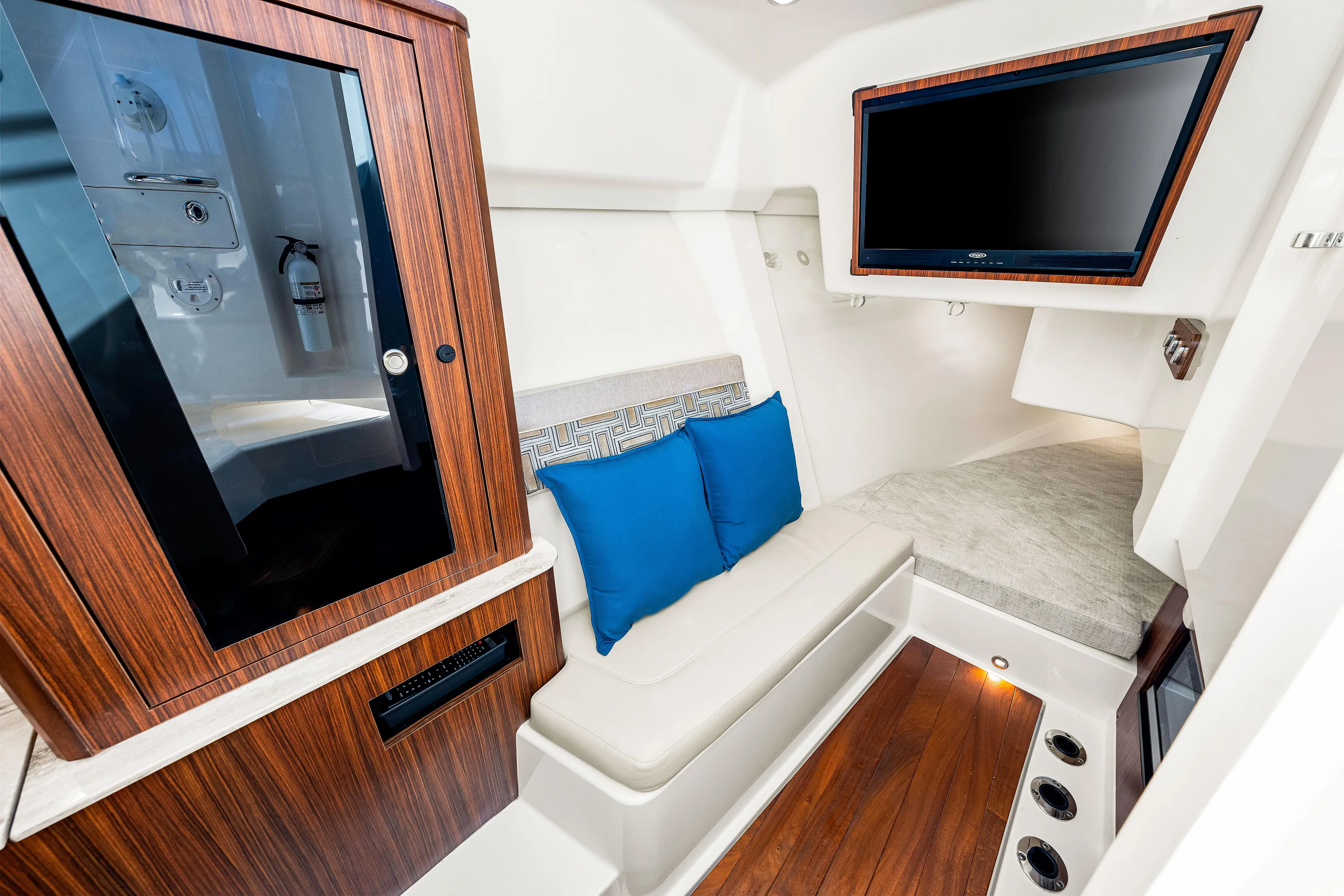 Conspirasea Yacht Photos Pics 2021 Pursuit DC 365 Dual Console cabin with seating, TV, and wood accents.