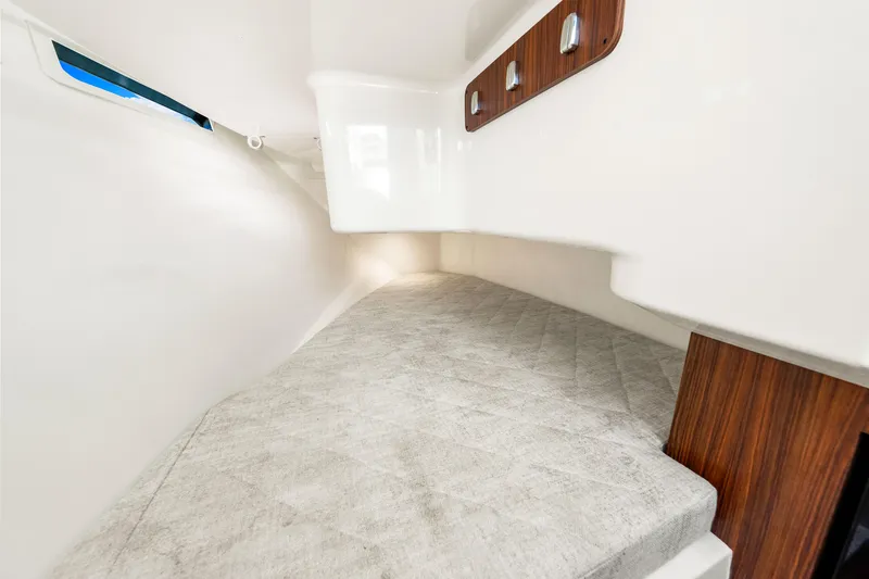 Conspirasea Yacht Photos Pics 2021 Pursuit DC 365 Dual Console cabin interior with cushioned seating and wooden accents.