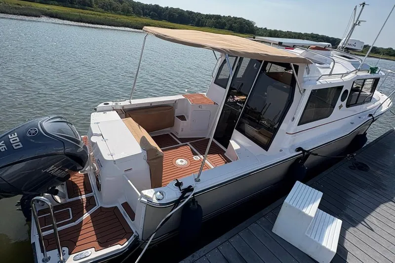  Yacht Photos Pics 2023 Ranger Tugs R-27 boat docked, featuring a Yamaha 300 engine and spacious deck.