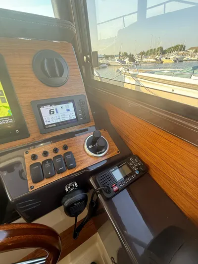  Yacht Photos Pics 2023 Ranger Tugs R-27 helm with navigation controls and marina view.