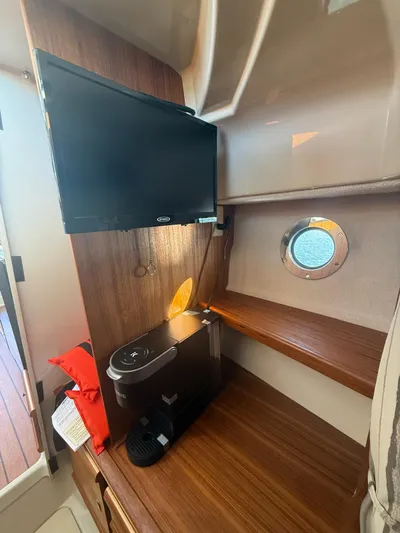  Yacht Photos Pics Interior of 2023 Ranger Tugs R-27 with TV, coffee maker, and porthole window.