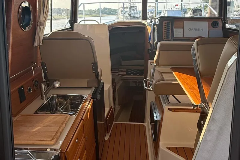  Yacht Photos Pics Interior of 2023 Ranger Tugs R-27 boat with kitchen and seating area.