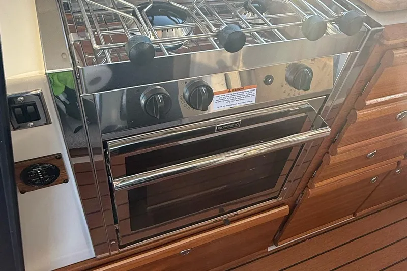  Yacht Photos Pics 2023 Ranger Tugs R-27 kitchen with stainless steel stove and oven.