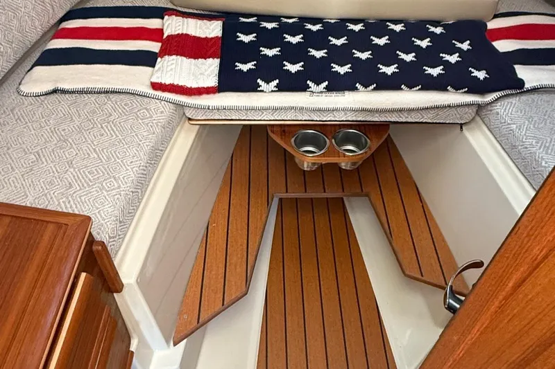  Yacht Photos Pics 2023 Ranger Tugs R-27 interior with American flag-themed decor and wooden flooring.