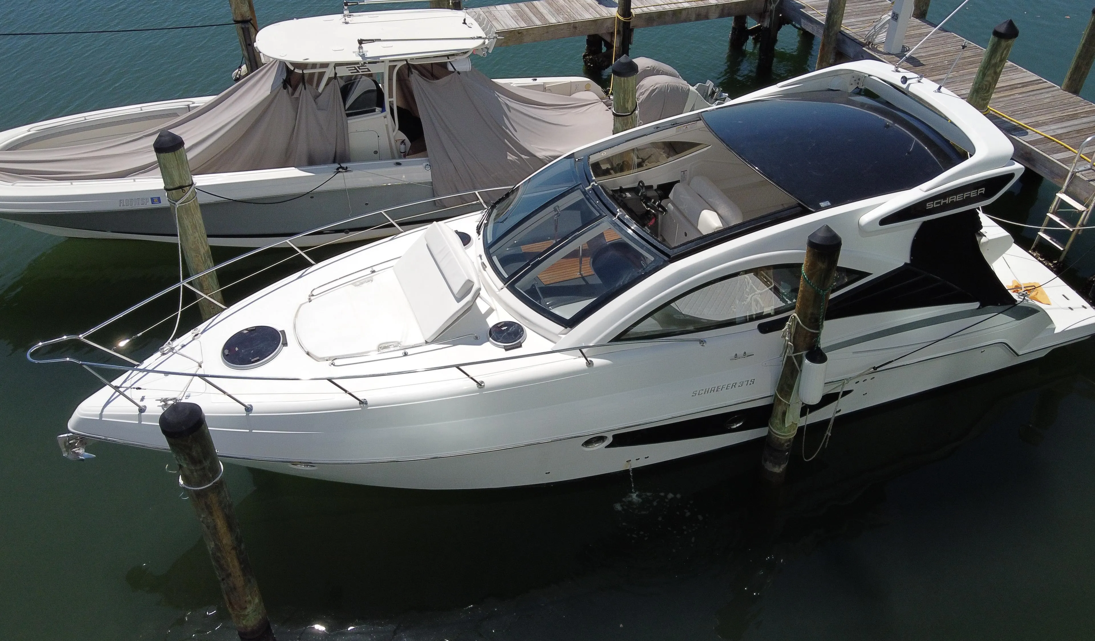 2023 Schaefer 375 HT yacht docked at marina, aerial view.