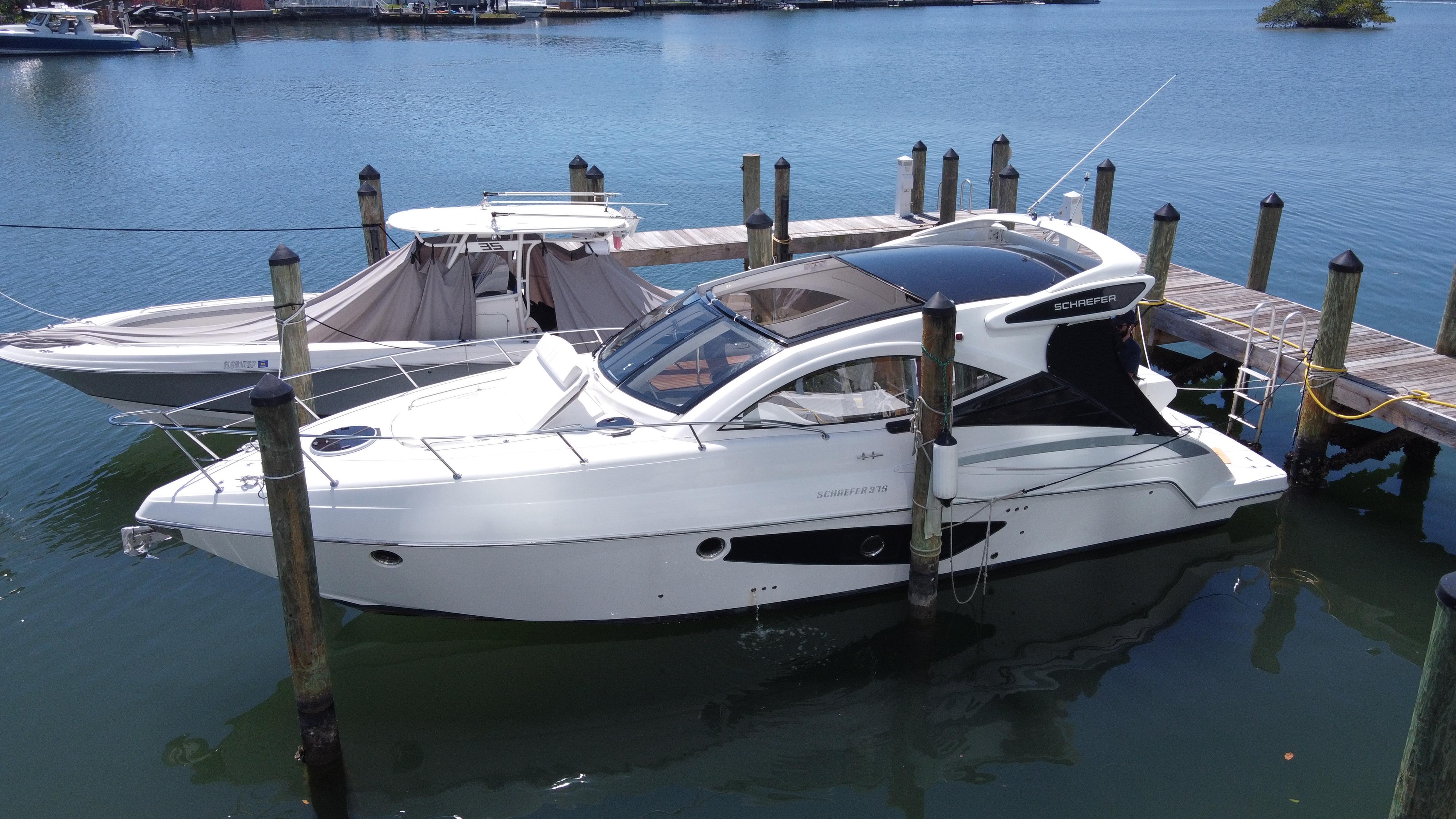 2023 Schaefer 375 HT yacht docked in a marina, showcasing sleek design and modern features.