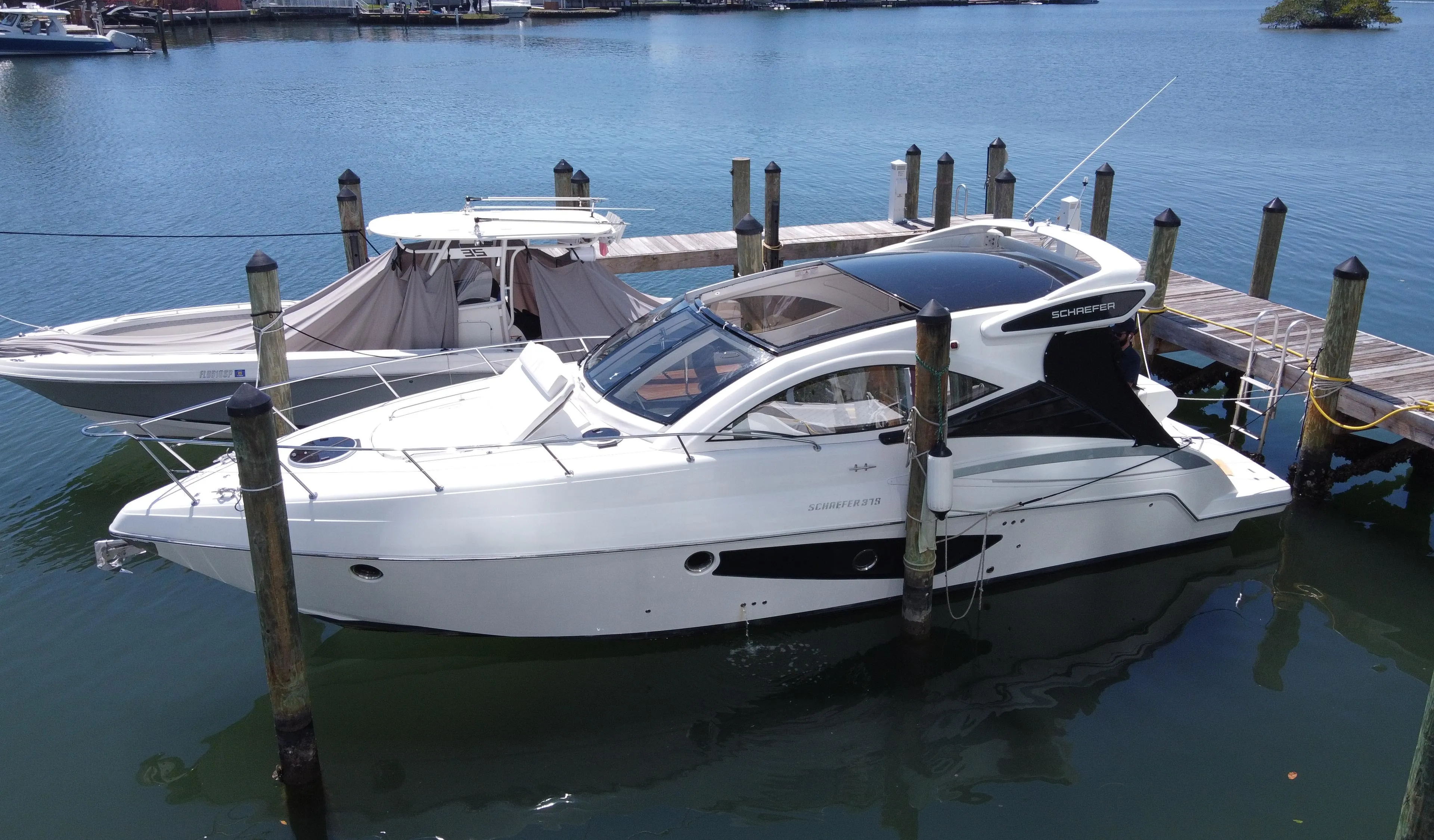 2023 Schaefer 375 HT yacht docked in a marina, showcasing sleek design and modern features.