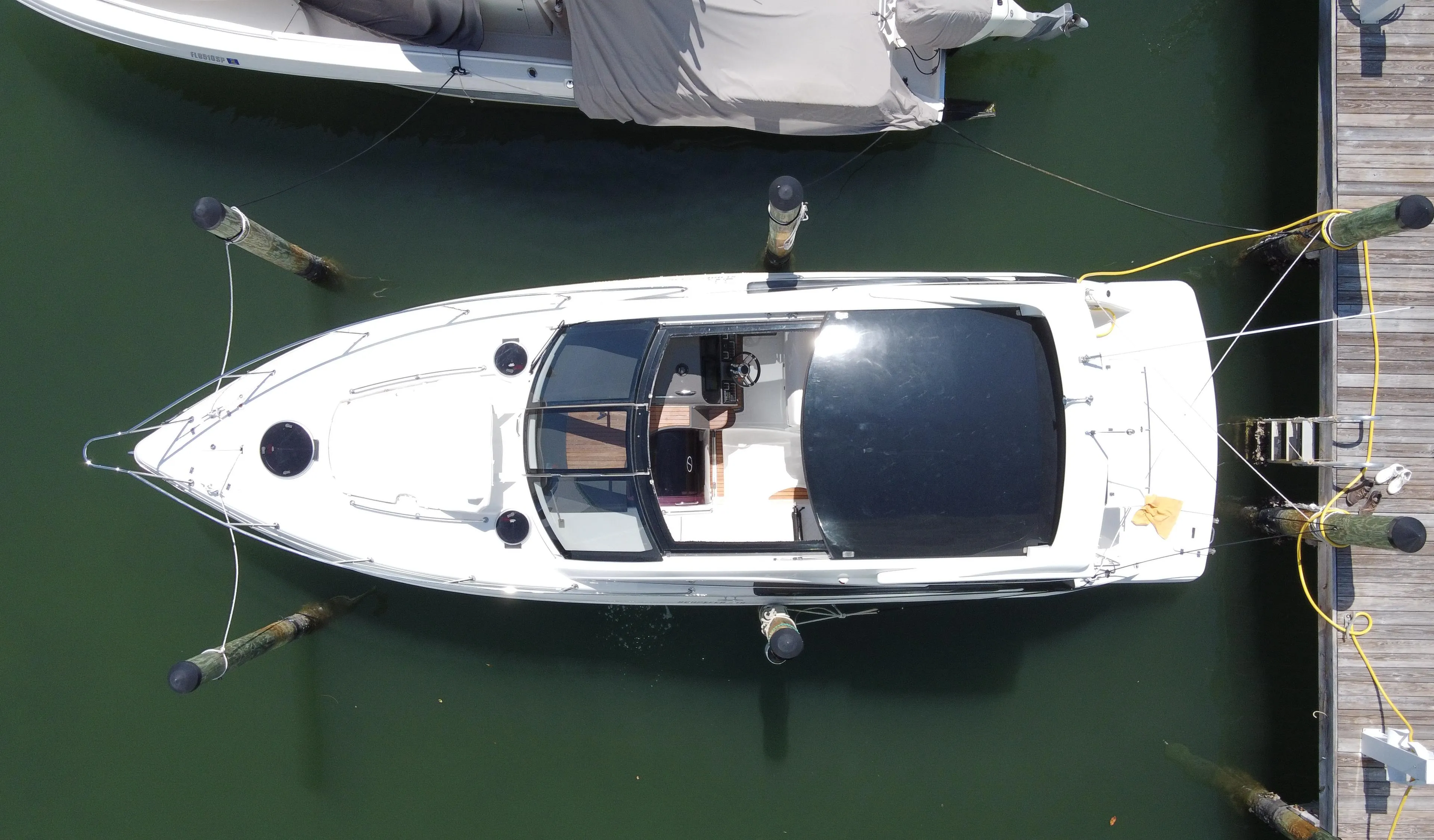 Overhead view of a 2023 Schaefer 375 HT boat docked at a marina.