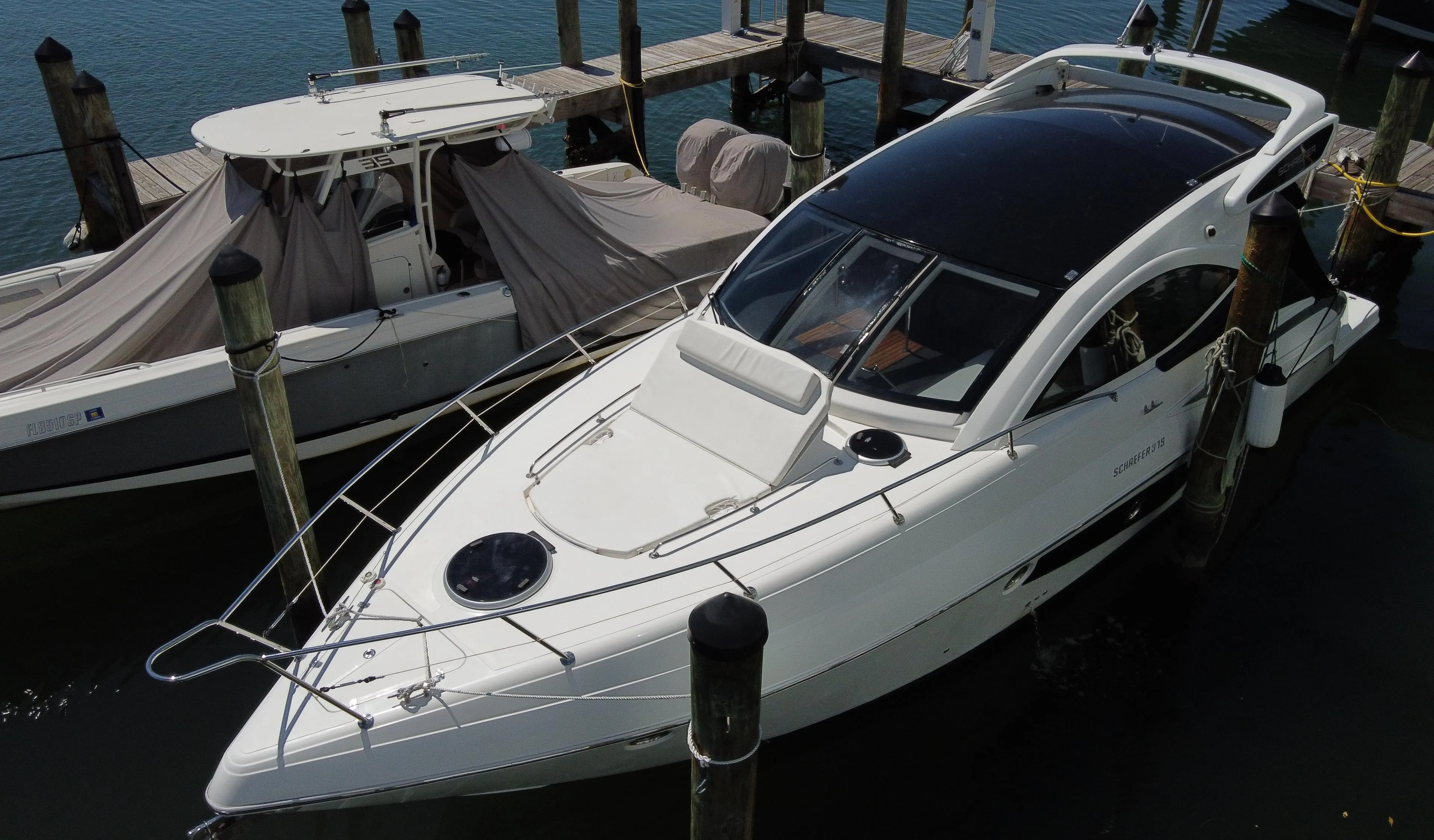 2023 Schaefer 375 HT yacht docked at marina, sleek design, white exterior.