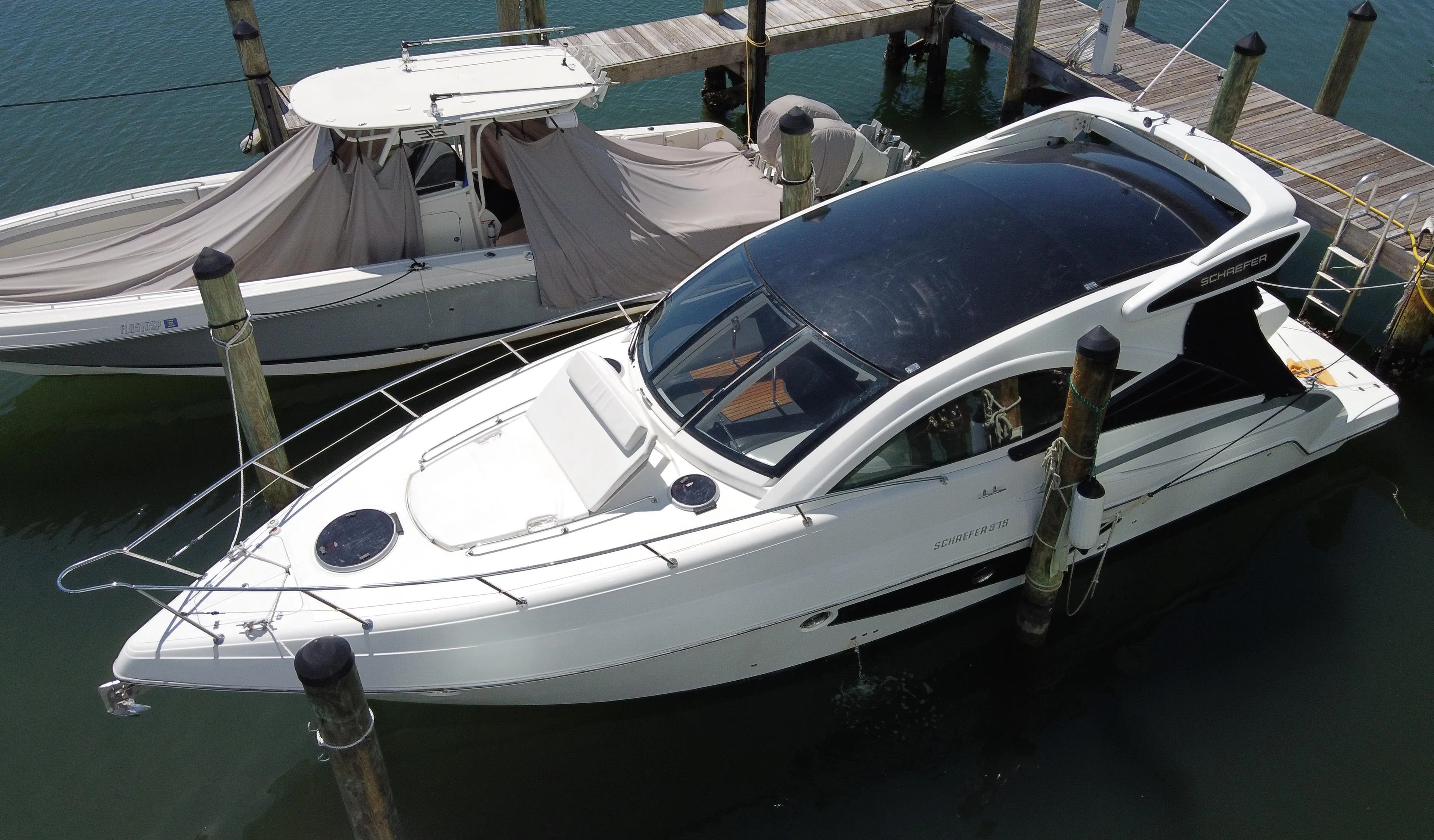 2023 Schaefer 375 HT yacht docked at marina, aerial view.