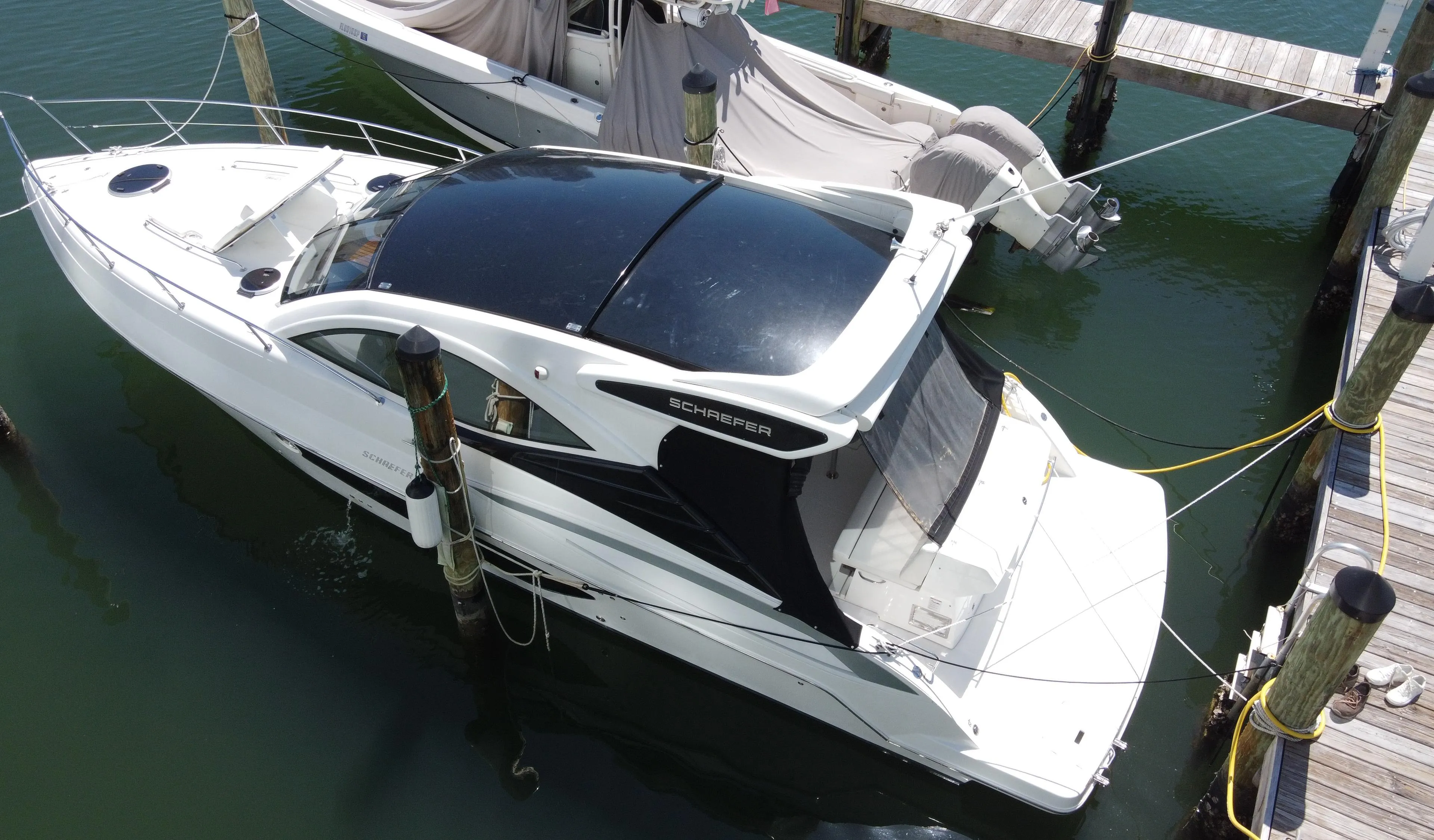 2023 Schaefer 375 HT yacht docked at marina, aerial view.