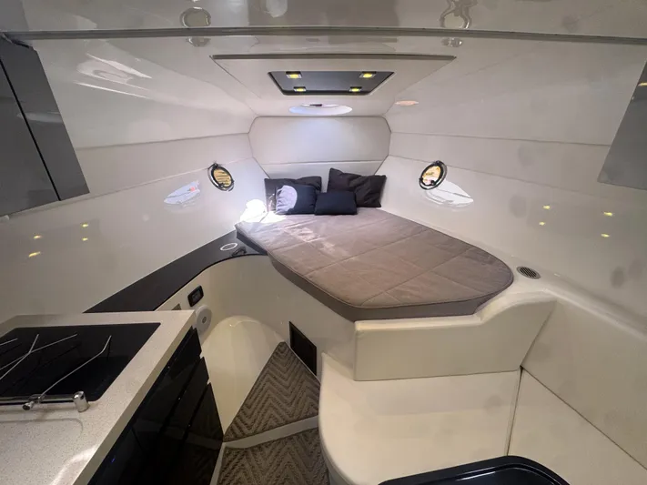  Yacht Photos Pics 2023 Schaefer 375 HT cabin interior with bed, modern design, and compact kitchen area.