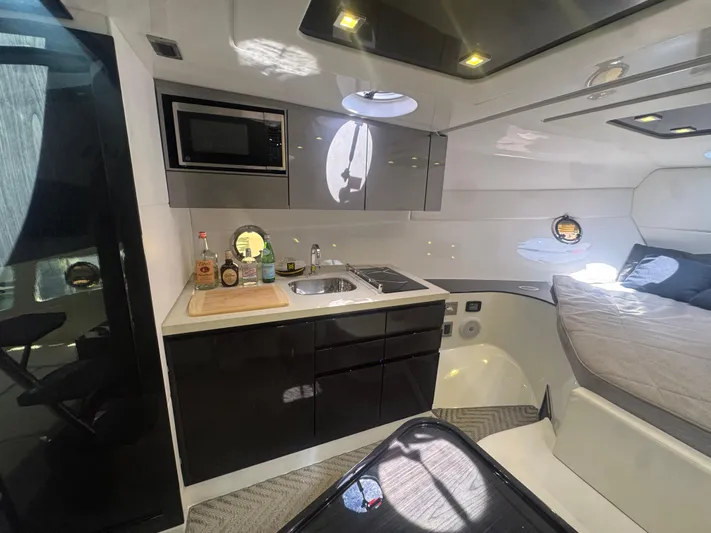  Yacht Photos Pics Modern interior of 2023 Schaefer 375 HT yacht with kitchenette and bed.