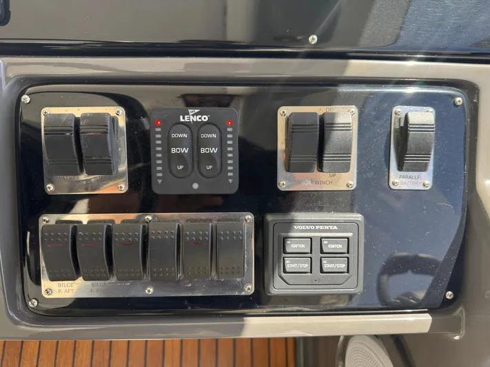  Yacht Photos Pics Control panel of 2023 Schaefer 375 HT boat with switches and Lenco trim tab controls.