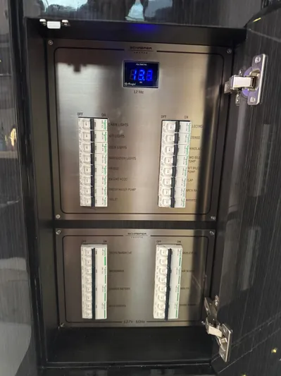  Yacht Photos Pics Electrical panel inside 2023 Schaefer 375 HT boat, featuring circuit breakers and digital display.