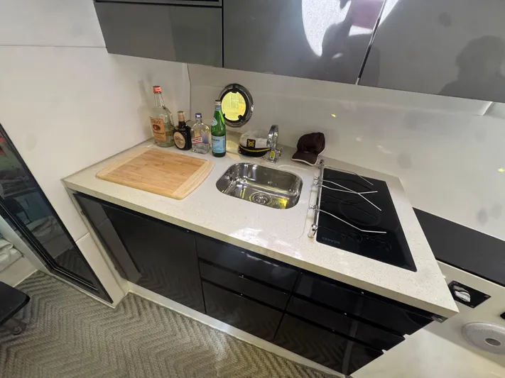  Yacht Photos Pics Modern kitchen in 2023 Schaefer 375 HT yacht with sink, stove, and countertop.