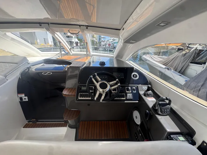  Yacht Photos Pics Interior of 2023 Schaefer 375 HT yacht with modern helm and wooden accents.