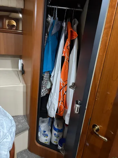 White Lightning Yacht Photos Pics Closet inside 2003 Cruisers Yachts 4270 Express with clothes and paper towels.