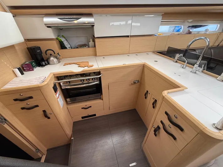 Padraigin II Yacht Photos Pics Modern kitchen in 2016 Jeanneau Yachts 58, featuring sleek cabinetry and stainless steel appliances.