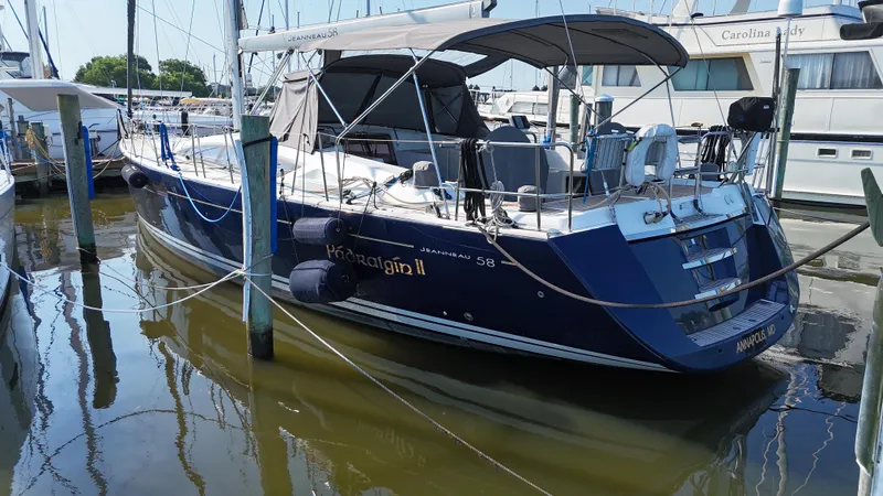 Padraigin II Yacht Photos Pics 2016 Jeanneau Yachts 58 docked in marina, blue hull, covered cockpit.