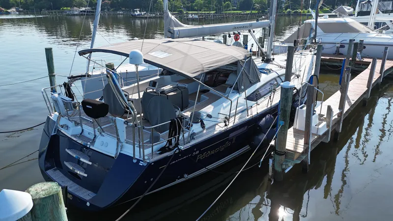 Padraigin II Yacht Photos Pics 2016 Jeanneau Yachts 58 docked at a marina, featuring sleek design and spacious deck.