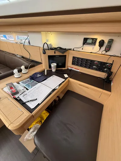 Padraigin II Yacht Photos Pics Navigation station inside 2016 Jeanneau Yachts 58, featuring control panel and workspace.