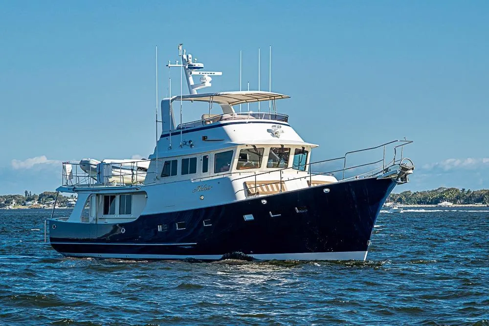 2017 Kadey-Krogen 58EB yacht cruising on open water under clear blue skies.