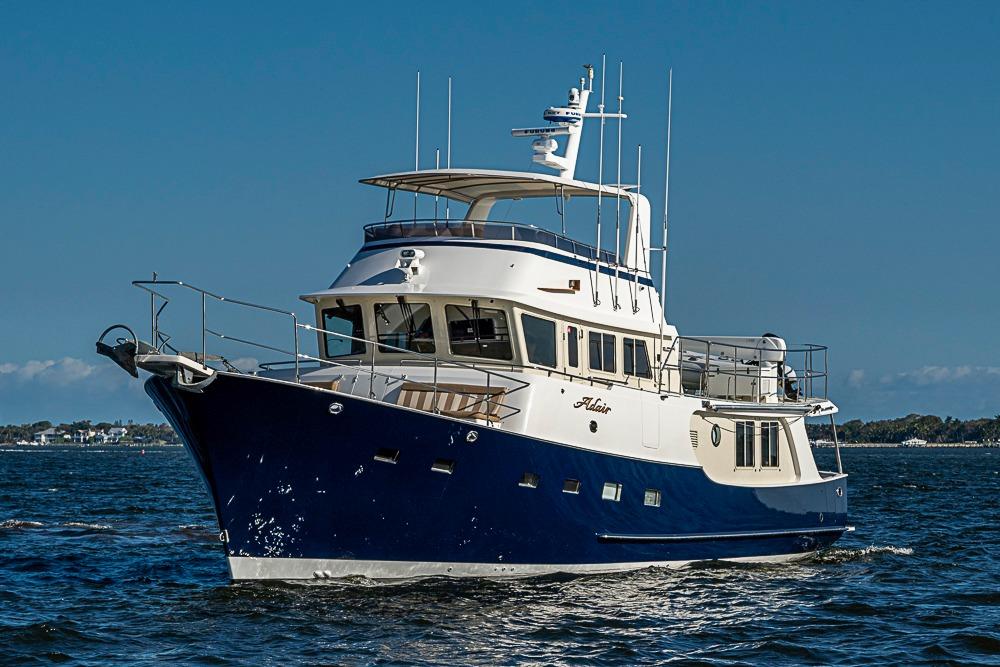 2017 Kadey-Krogen 58EB yacht cruising on open water under clear blue skies.