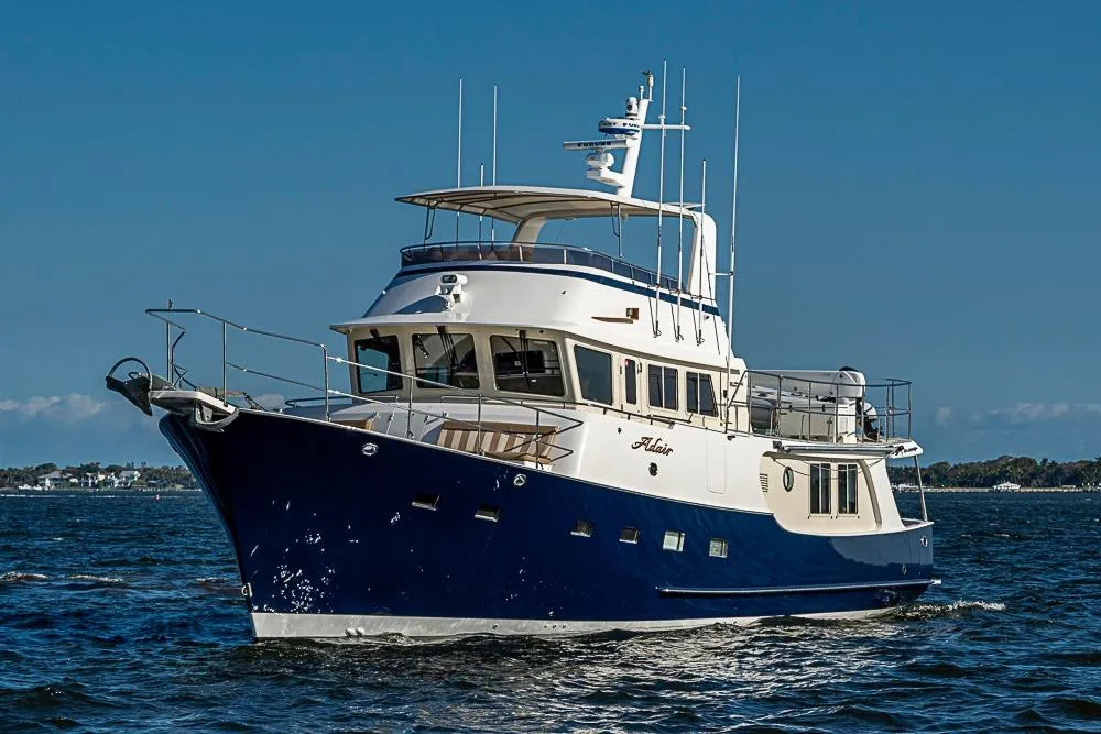 2017 Kadey-Krogen 58EB yacht cruising on open water under clear blue skies.