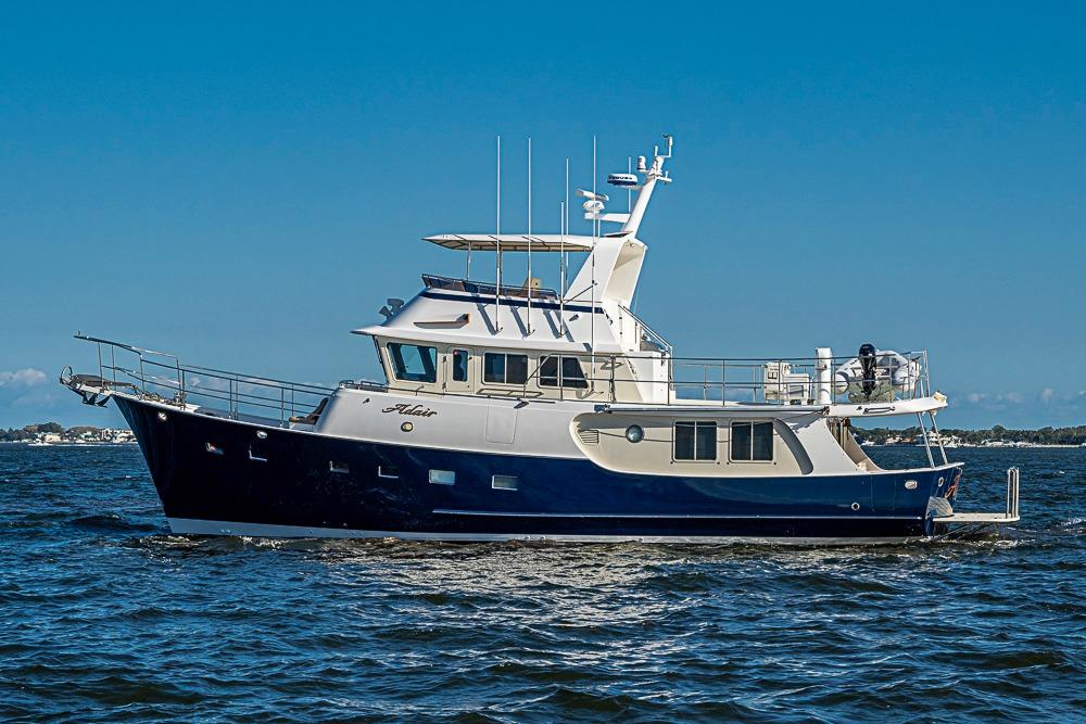 Kadey-Krogen 58EB 2017 yacht cruising on open water under clear blue sky.