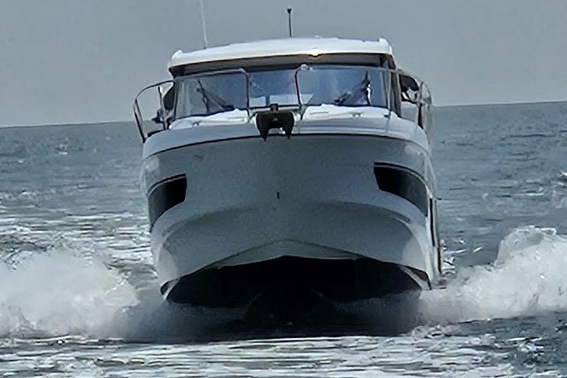  Yacht Photos Pics 2023 Beneteau Antares 9 cruising on open water, front view.