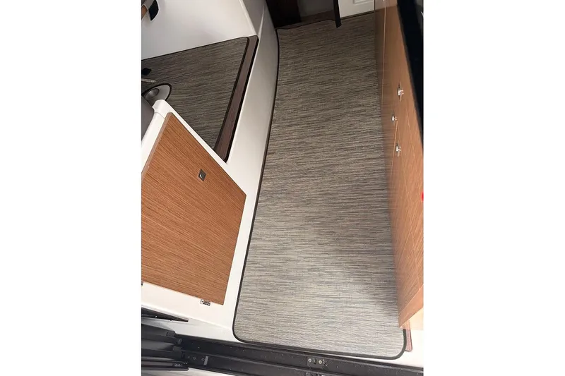  Yacht Photos Pics Interior view of 2023 Beneteau Antares 9, featuring modern wood cabinetry and flooring.