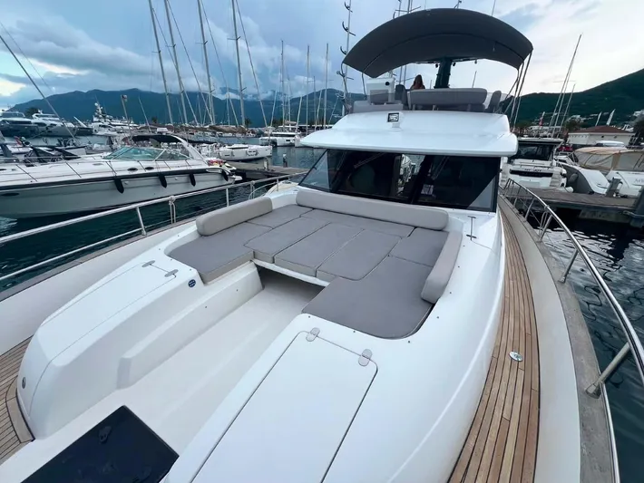 Obsession Yacht Photos Pics 2015 Azimut Magellano 53 yacht with spacious deck, docked in marina.