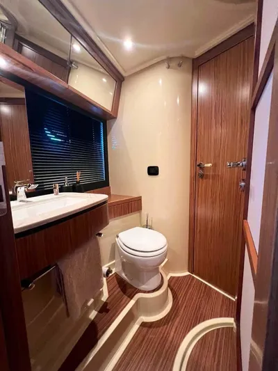 Obsession Yacht Photos Pics Luxurious bathroom in 2015 Azimut Magellano 53 yacht with wood accents and modern fixtures.