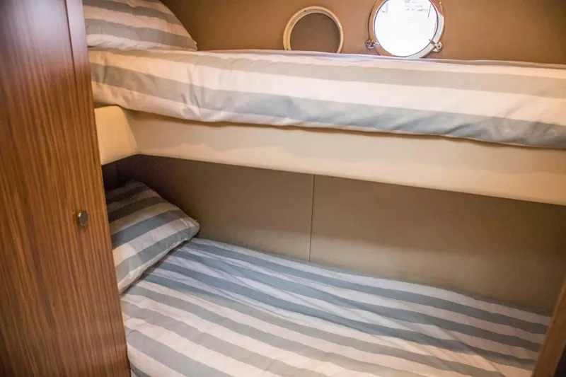 Obsession Yacht Photos Pics Bunk beds in 2015 Azimut Magellano 53 yacht cabin with striped bedding.