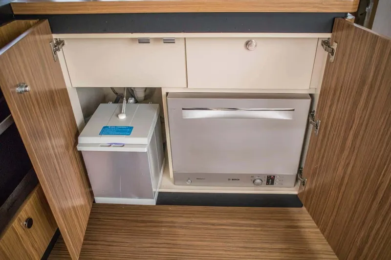 Obsession Yacht Photos Pics 2015 Azimut Magellano 53 yacht interior kitchen storage with dishwasher and trash bin.