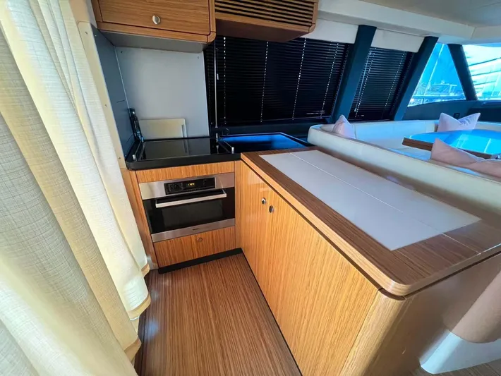 Obsession Yacht Photos Pics Interior of 2015 Azimut Magellano 53 yacht, featuring modern kitchen and wood finishes.