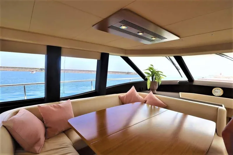 Obsession Yacht Photos Pics Luxurious interior of 2015 Azimut Magellano 53 yacht with elegant dining area and sea view.
