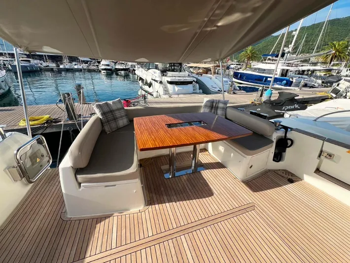 Obsession Yacht Photos Pics Luxurious 2015 Azimut Magellano 53 yacht deck with seating and table, docked at marina.
