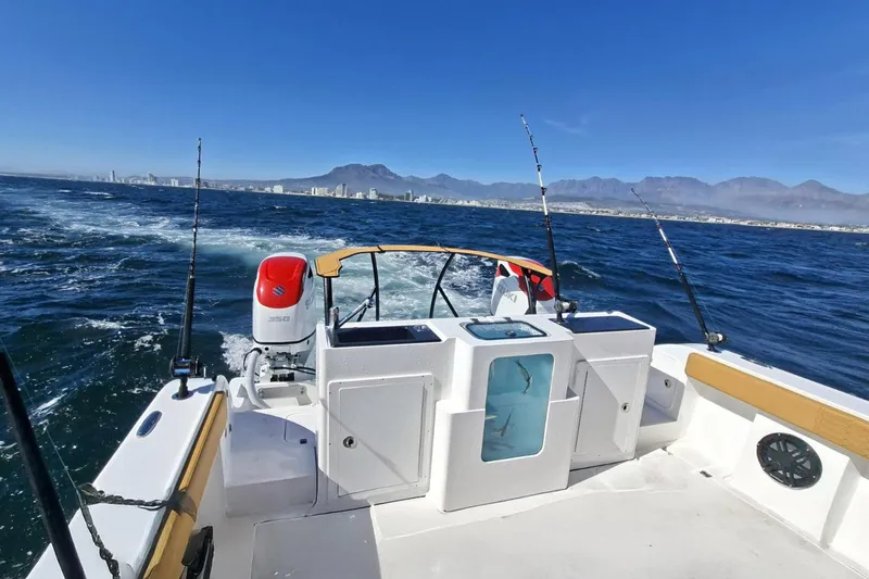  Yacht Photos Pics 2026 MVI Invicta 30CC boat cruising on open sea with fishing rods.