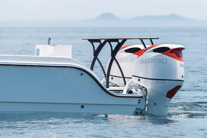  Yacht Photos Pics 2026 MVI Invicta 30CC boat with dual Suzuki outboard motors on the ocean.