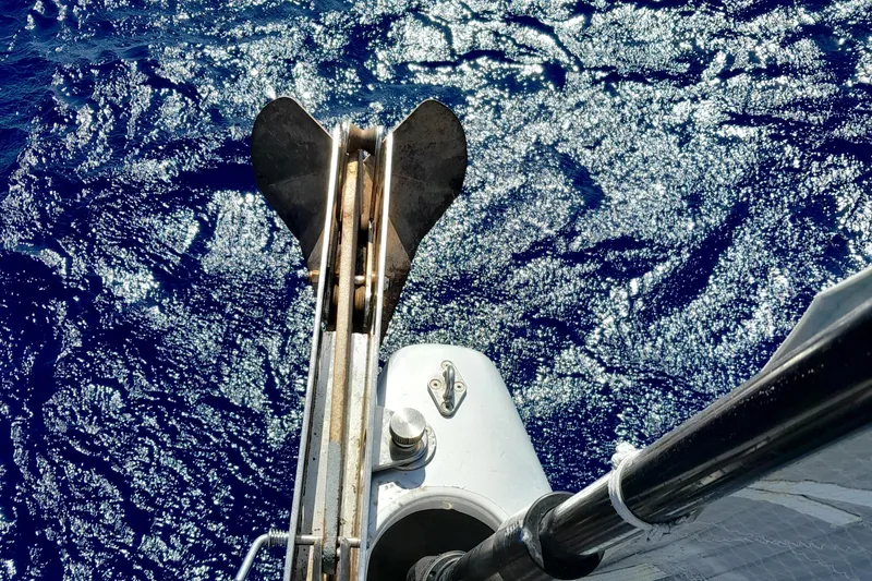  Yacht Photos Pics Bow view of 2010 Grand Soleil 54 yacht with anchor over sparkling blue sea.