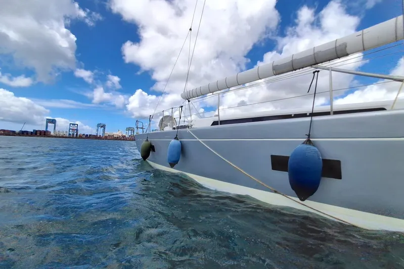  Yacht Photos Pics Grand Soleil 54 sailboat on water, 2010 model, with city skyline in background.