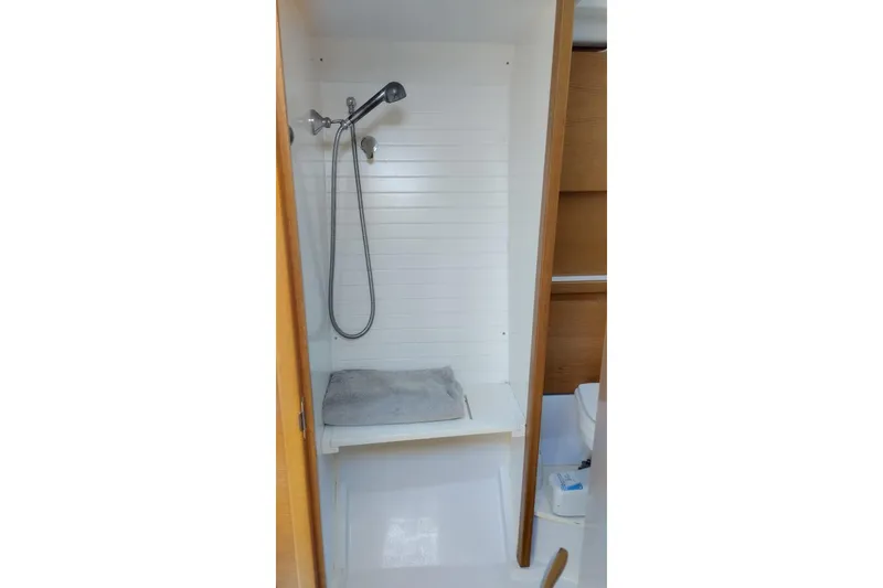  Yacht Photos Pics Shower area in 2010 Grand Soleil 54 yacht, featuring a handheld showerhead and towel.