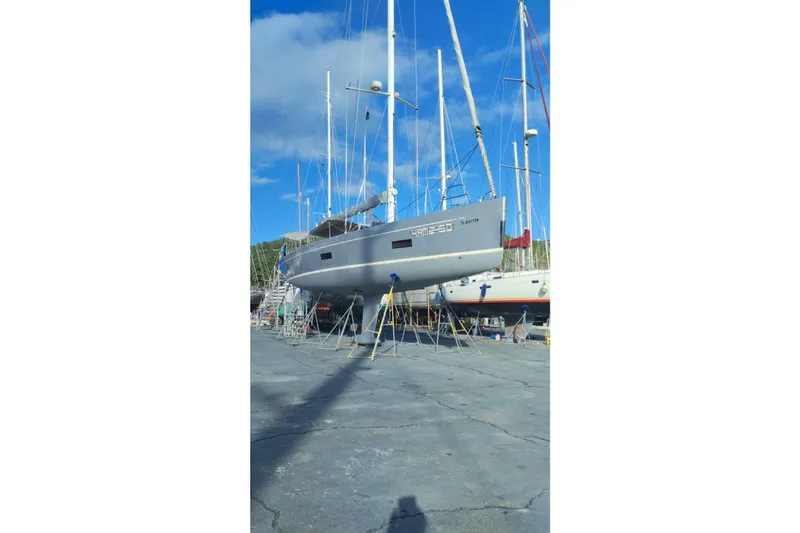  Yacht Photos Pics 2010 Grand Soleil 54 yacht on dry dock under clear blue sky.